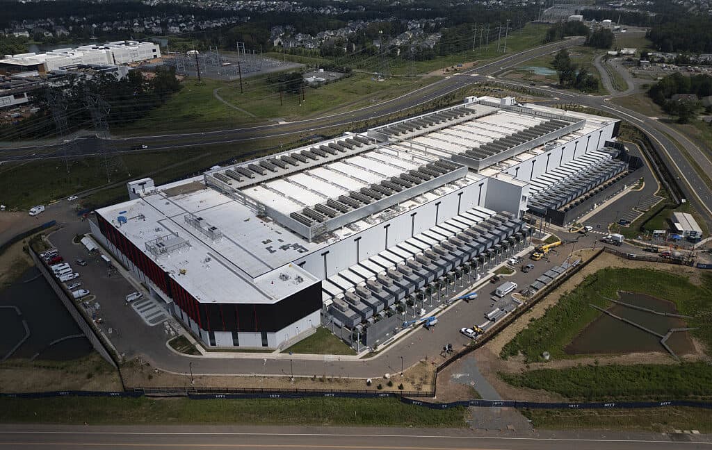 Large data center hall with server racks and industrial power infrastructure