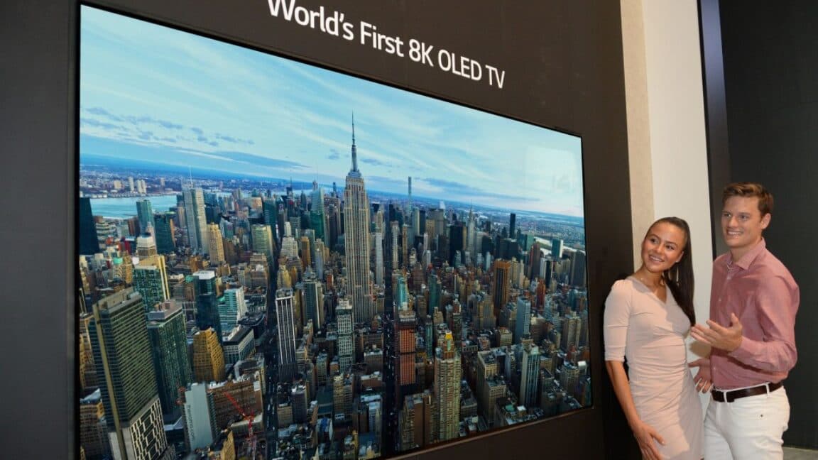 Large modern TV in a living room showing an ultra‑detailed video scene