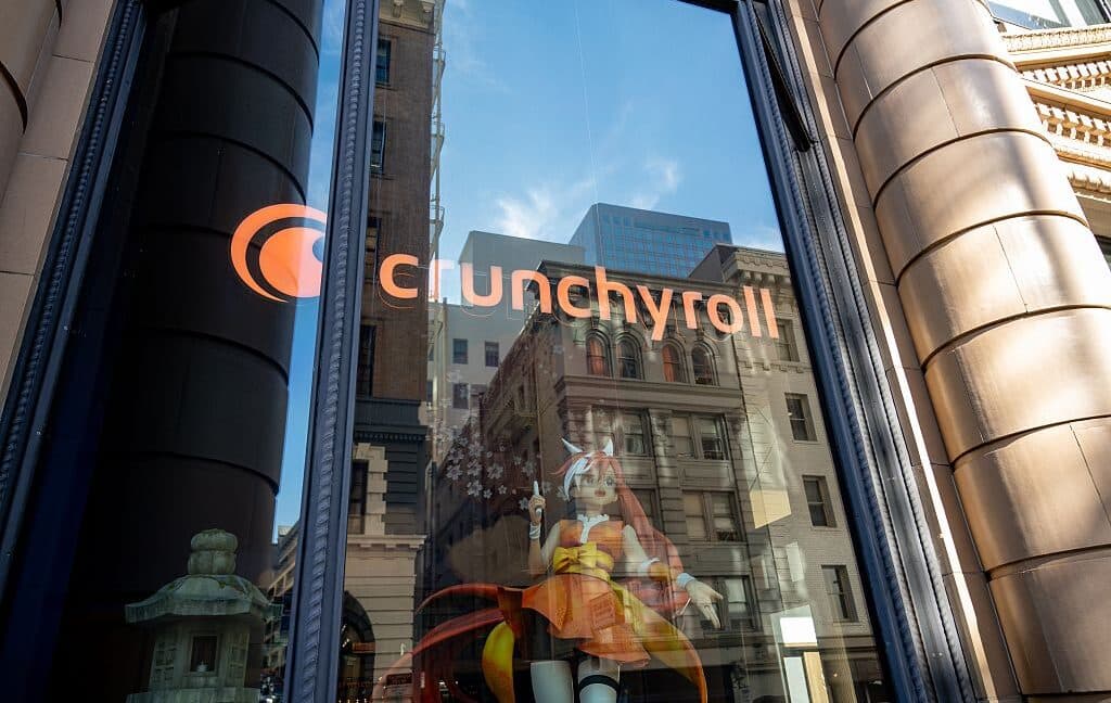 Crunchyroll streaming app displaying anime content on a TV and mobile device