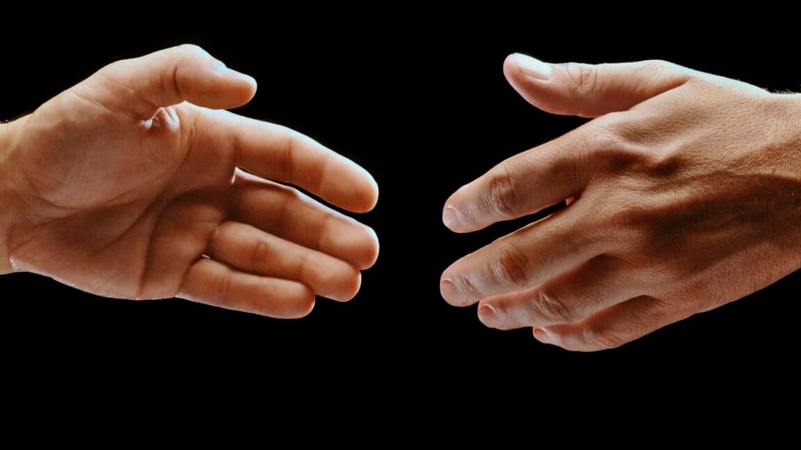 Logos of Paramount and Warner Bros. Discovery shown on a digital screen