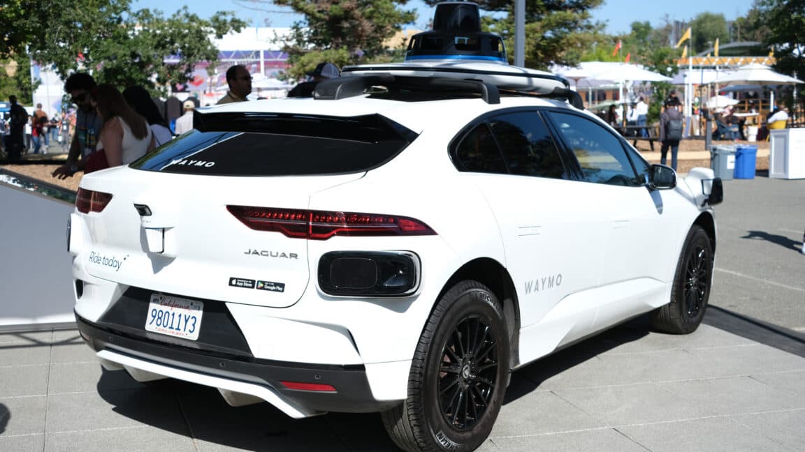 Waymo self-driving car navigating a city street, concept illustration