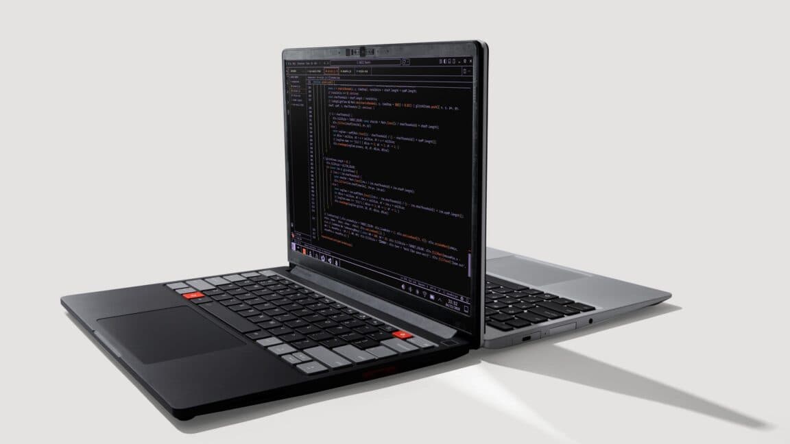 Two Framework laptops running Linux on a desk, highlighting modular, repairable design