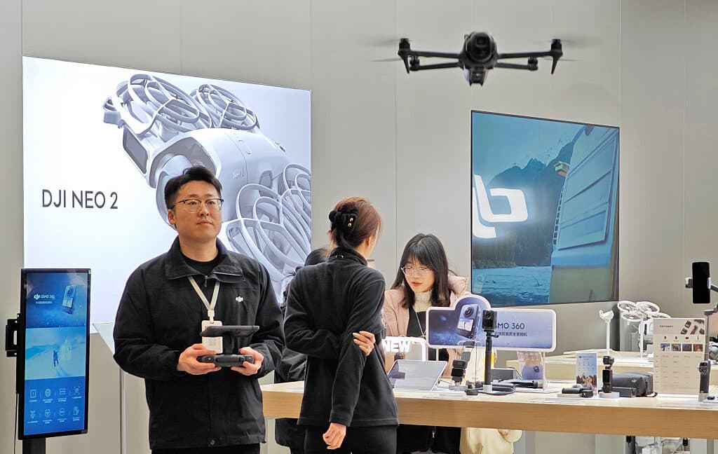 A consumer DJI drone being demonstrated inside an electronics store.