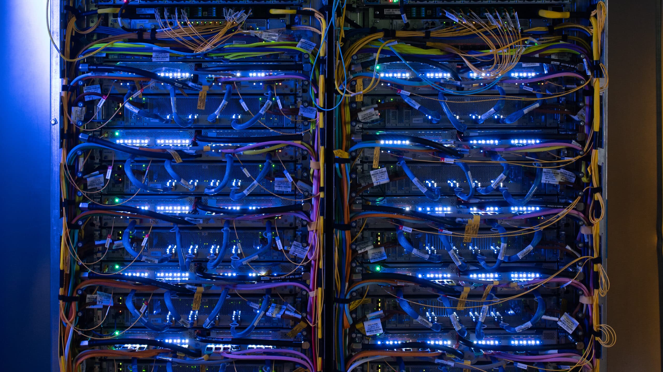 Rows of Google AI server racks filled with TPU accelerator hardware