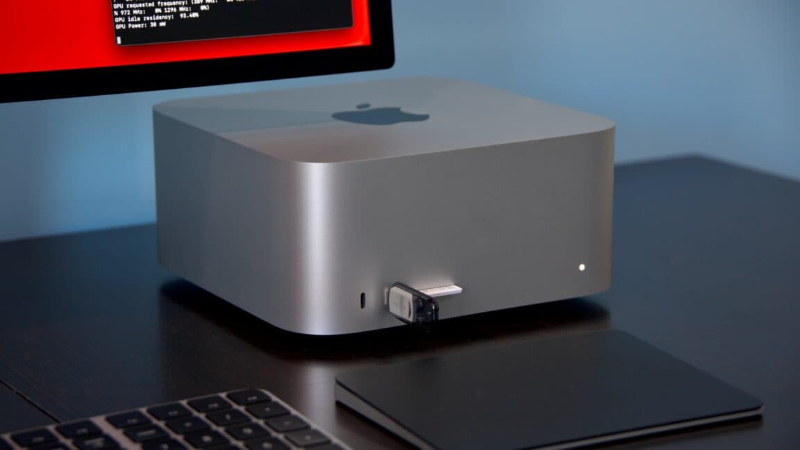Apple Mac mini and Mac Studio desktops on a modern office desk