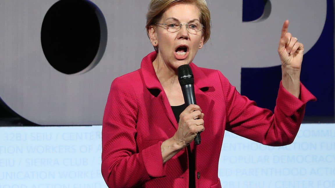 Rows of server racks inside a brightly lit industrial data center