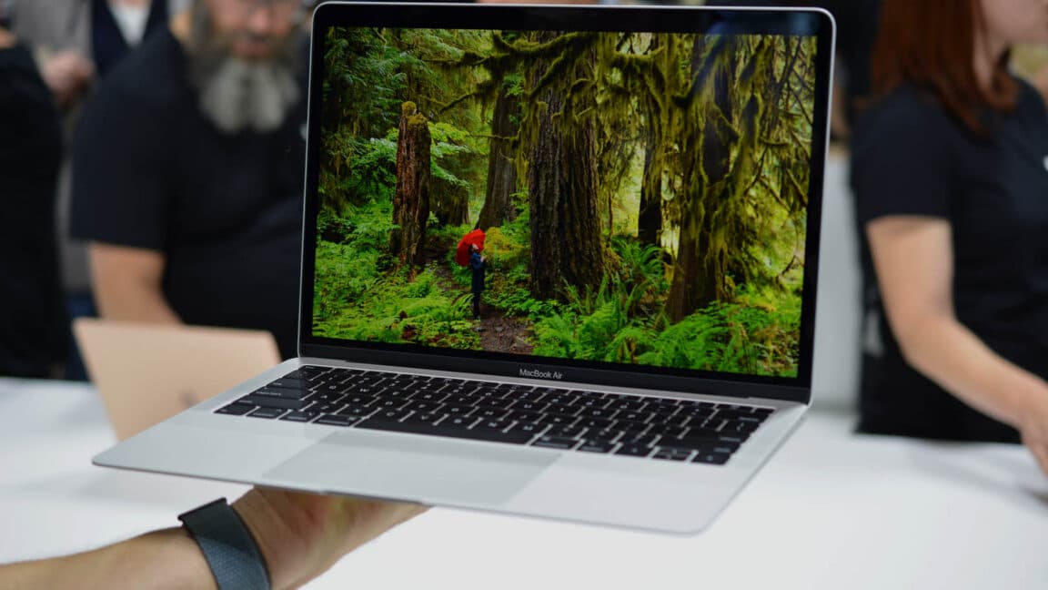 Lineup of Apple laptops and tablets on a table, highlighting similar designs but different sizes